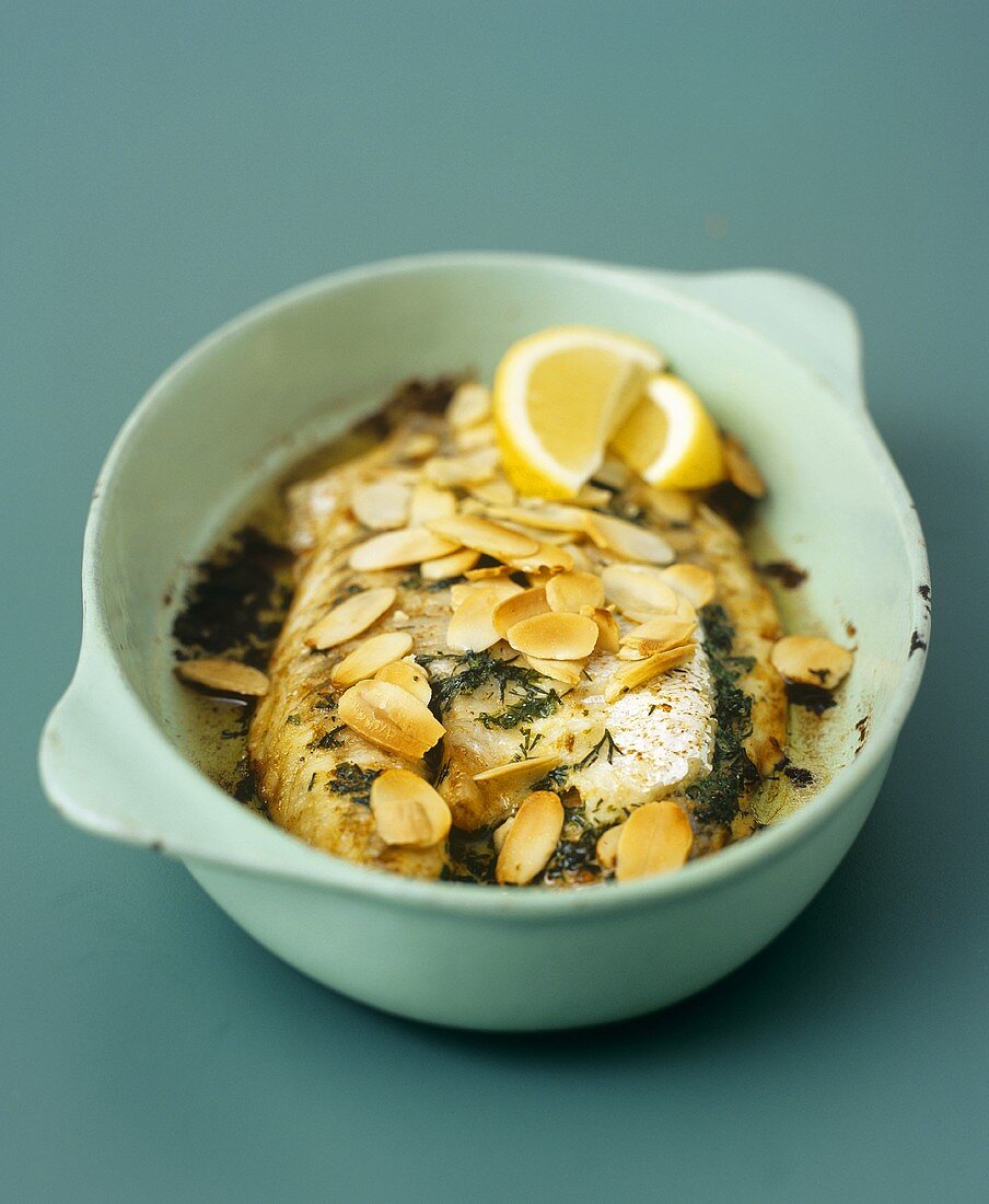 Baked fish fillets with herbs and flaked almonds