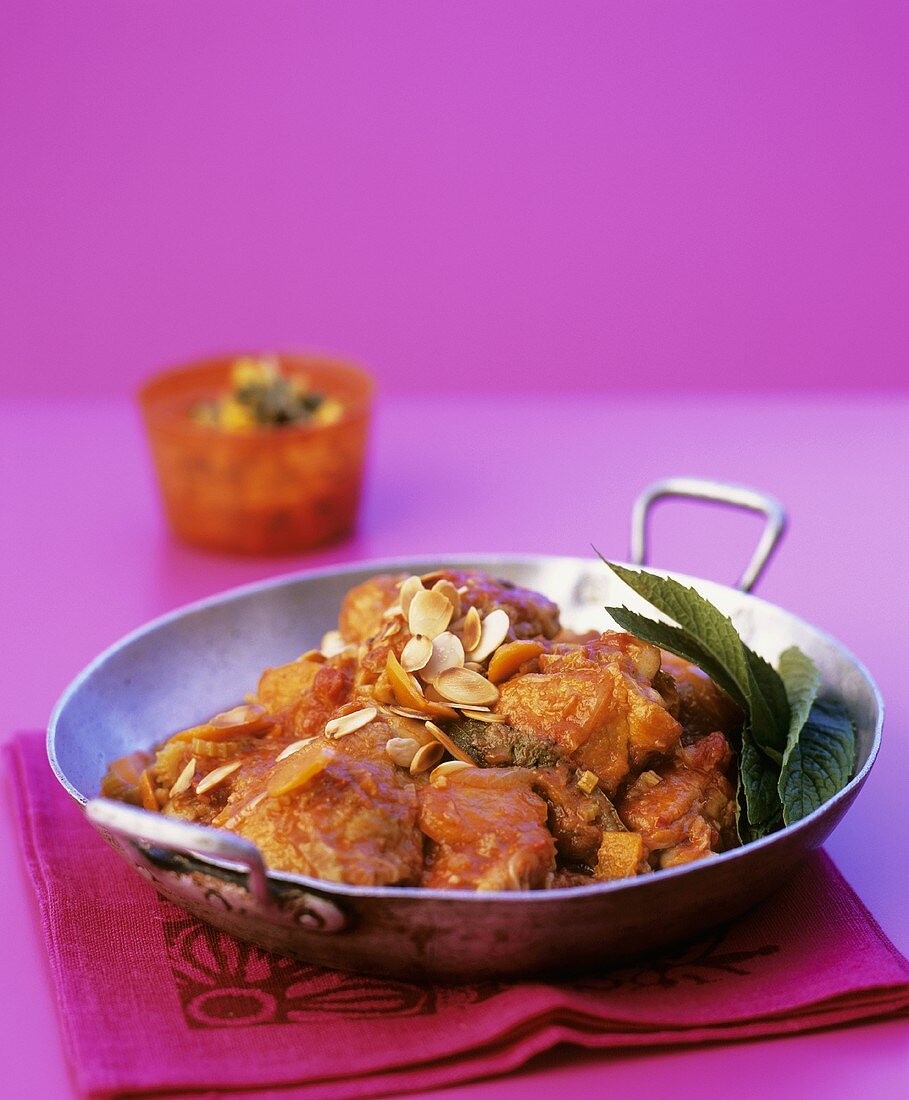 Chicken ragout with tomatoes, ginger and almonds