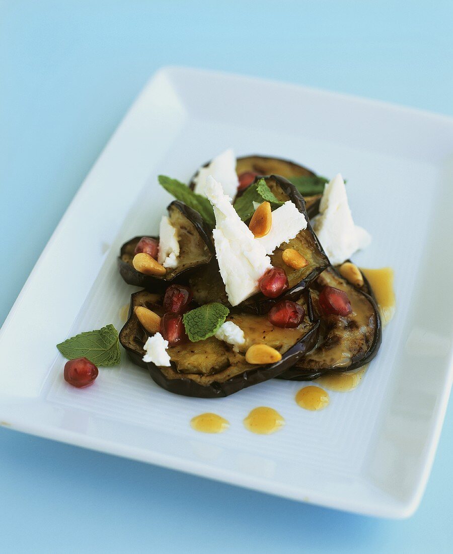 Aubergine slices with feta, pomegranate seeds and honey
