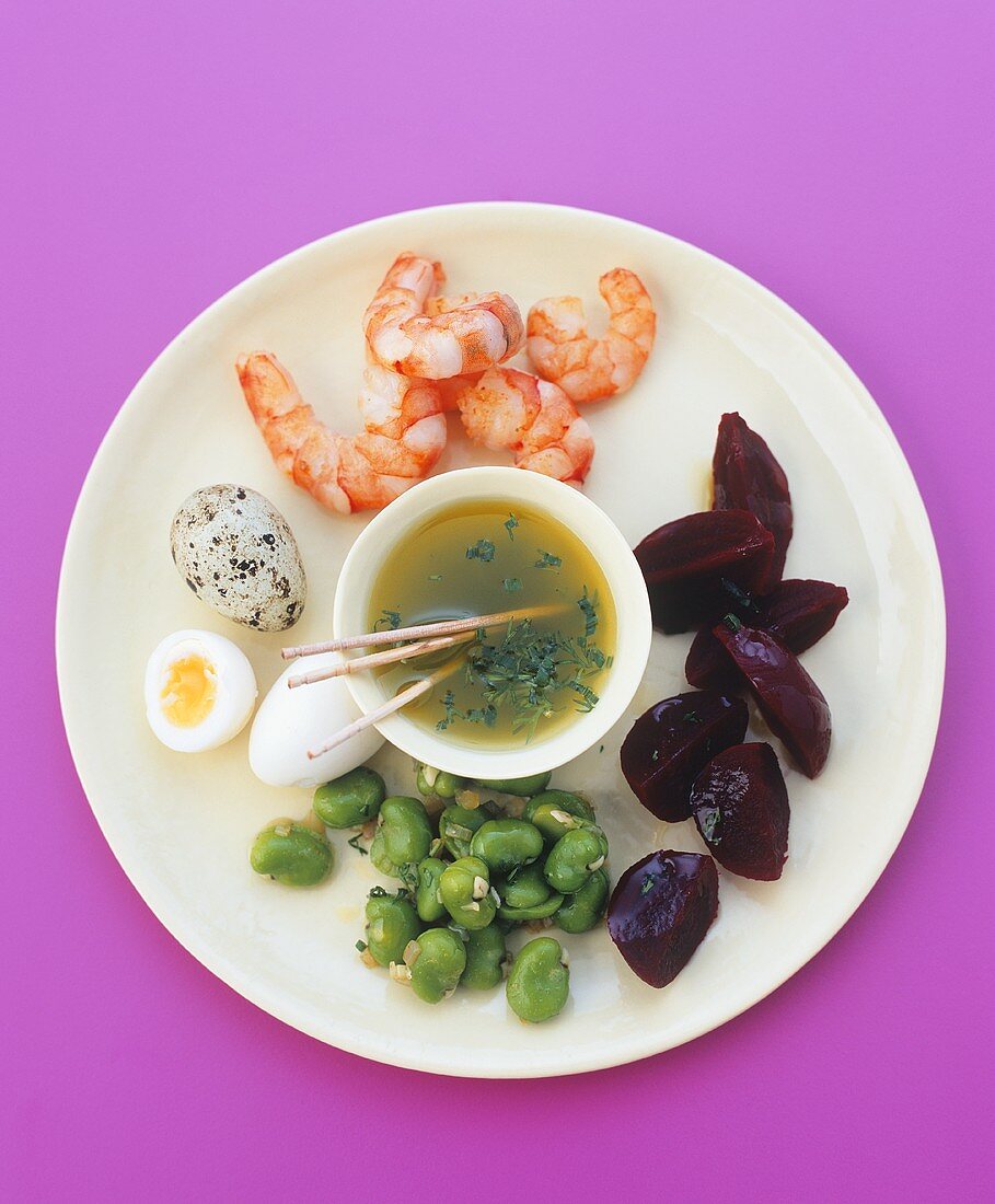 Plate of appetisers: prawns, vegetables, quails' eggs & dip