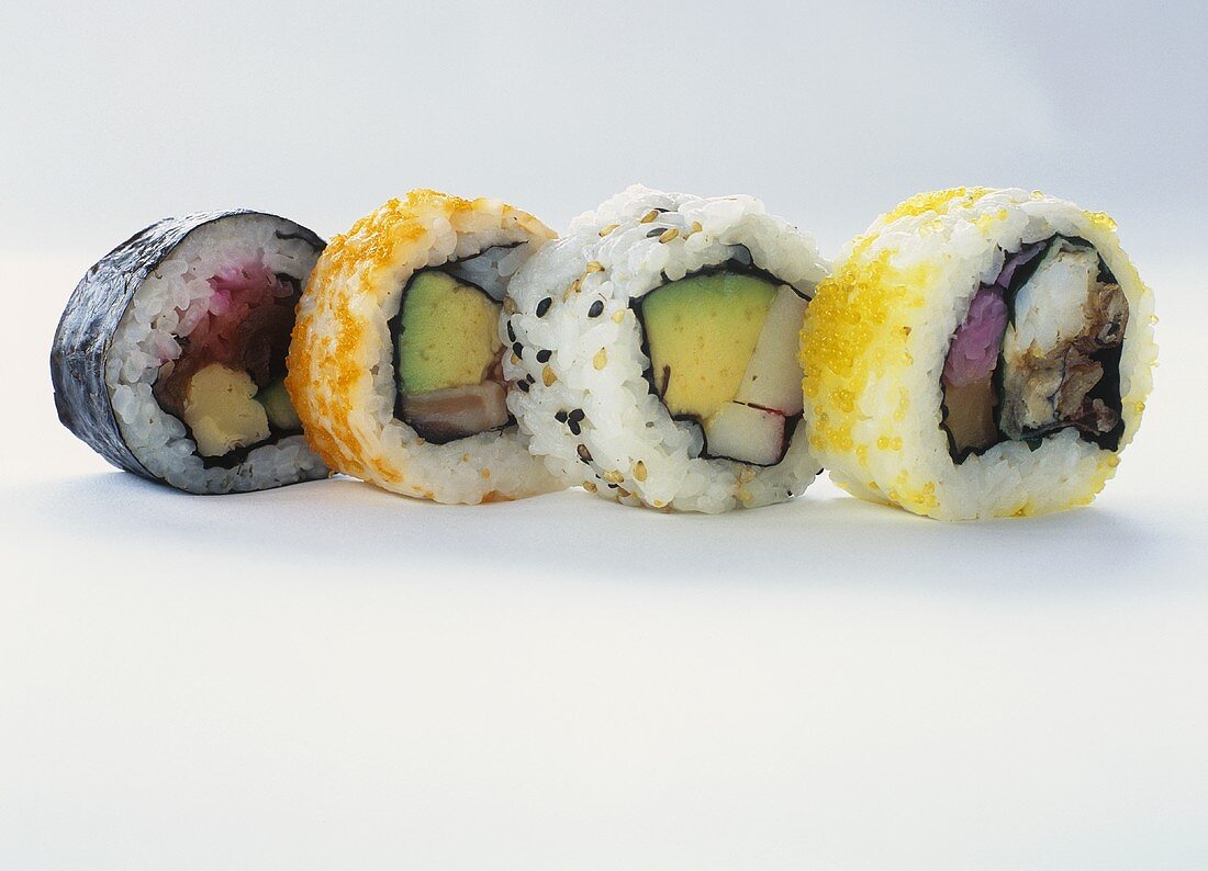 Four different maki sushi against white background
