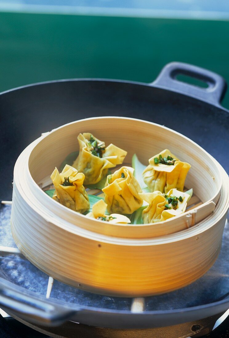Steamed wontons with spinach filling in steaming basket