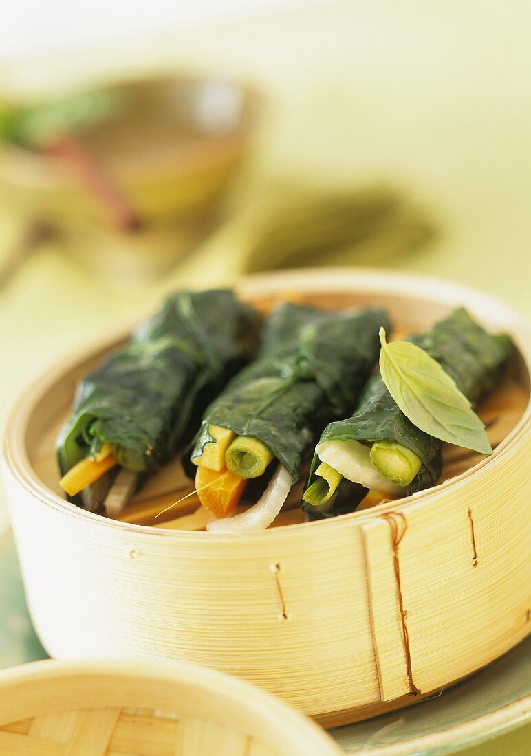 Steamed stuffed spinach leaves with curry coconut sauce
