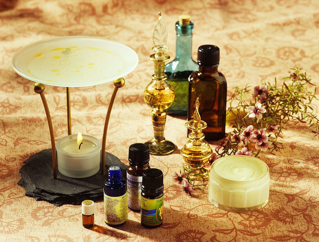 Aroma lamp, aromatic oils in small bottles, flacons and cream
