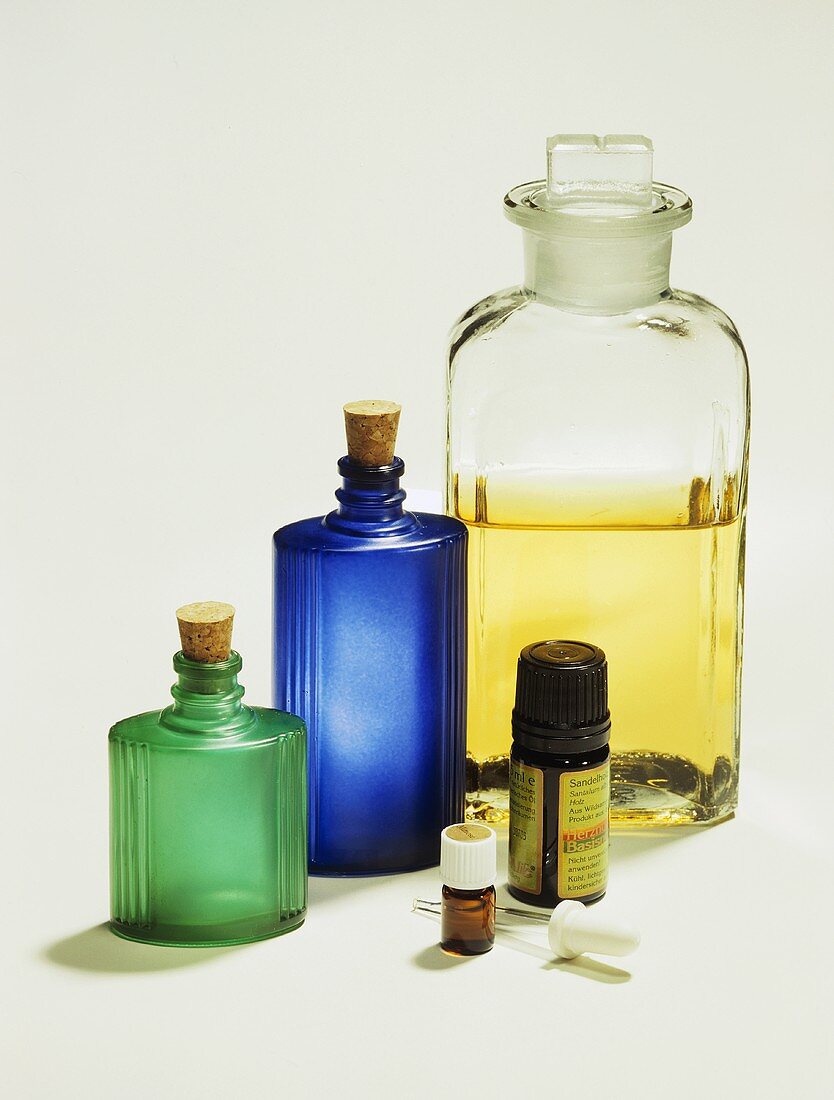 Sandlewood essential oil, storage bottles behind