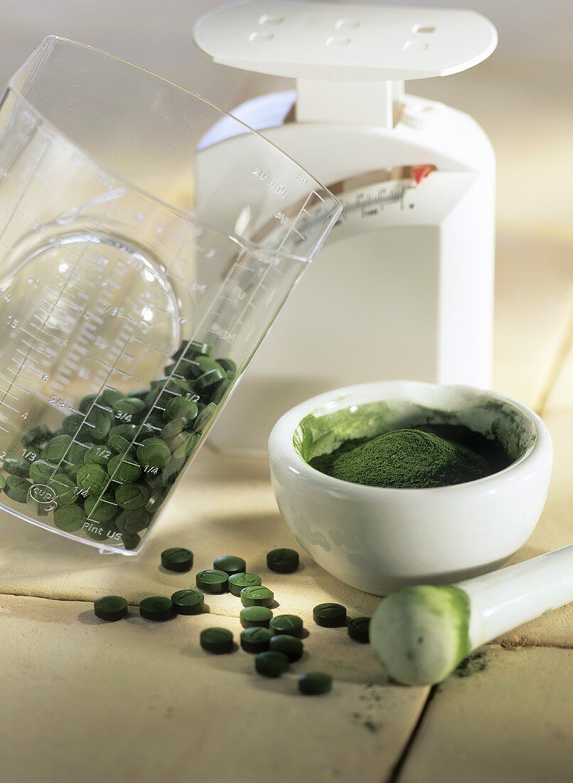 Crushing Chlorella tablets to powder in a mortar