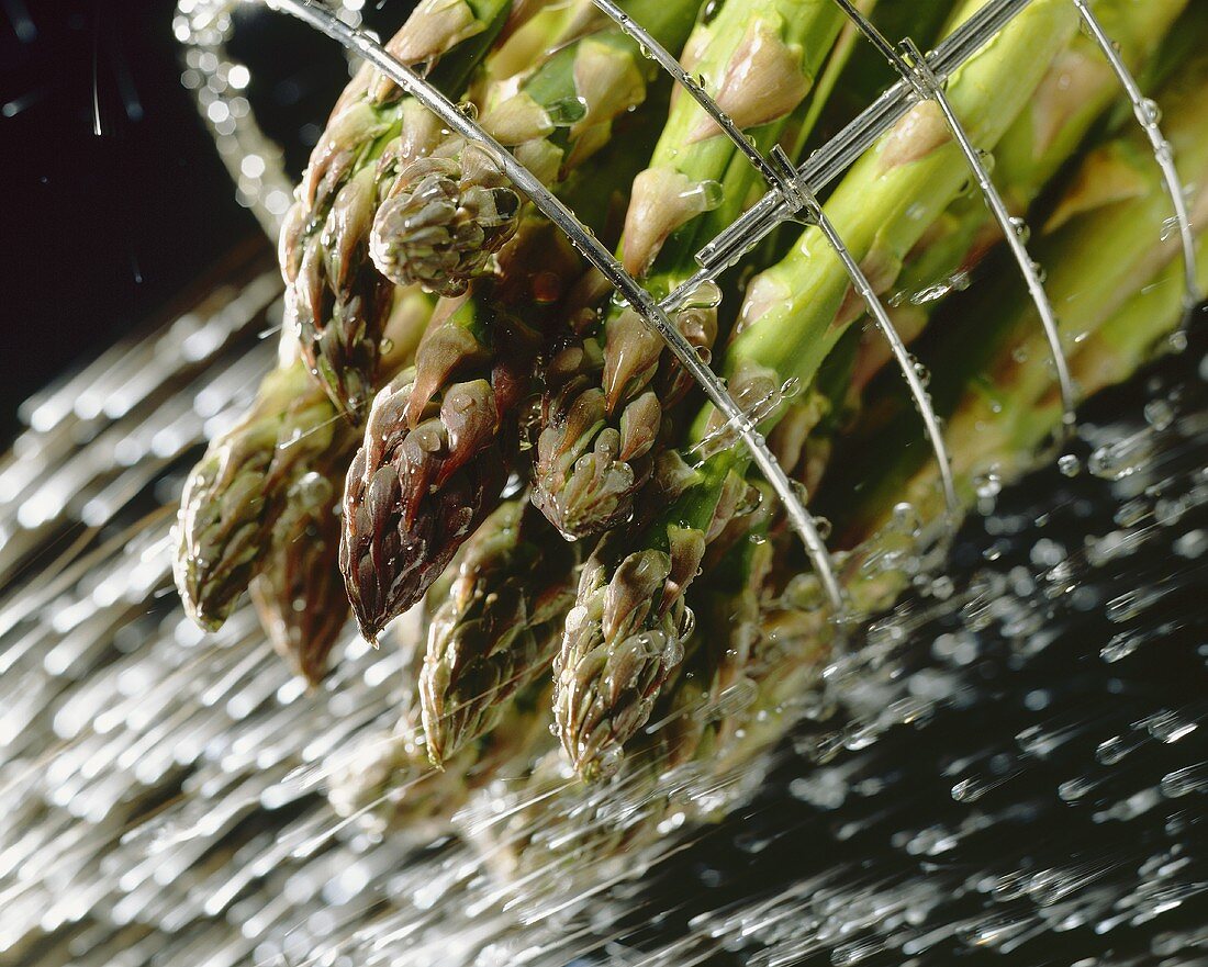Green asparagus being washed
