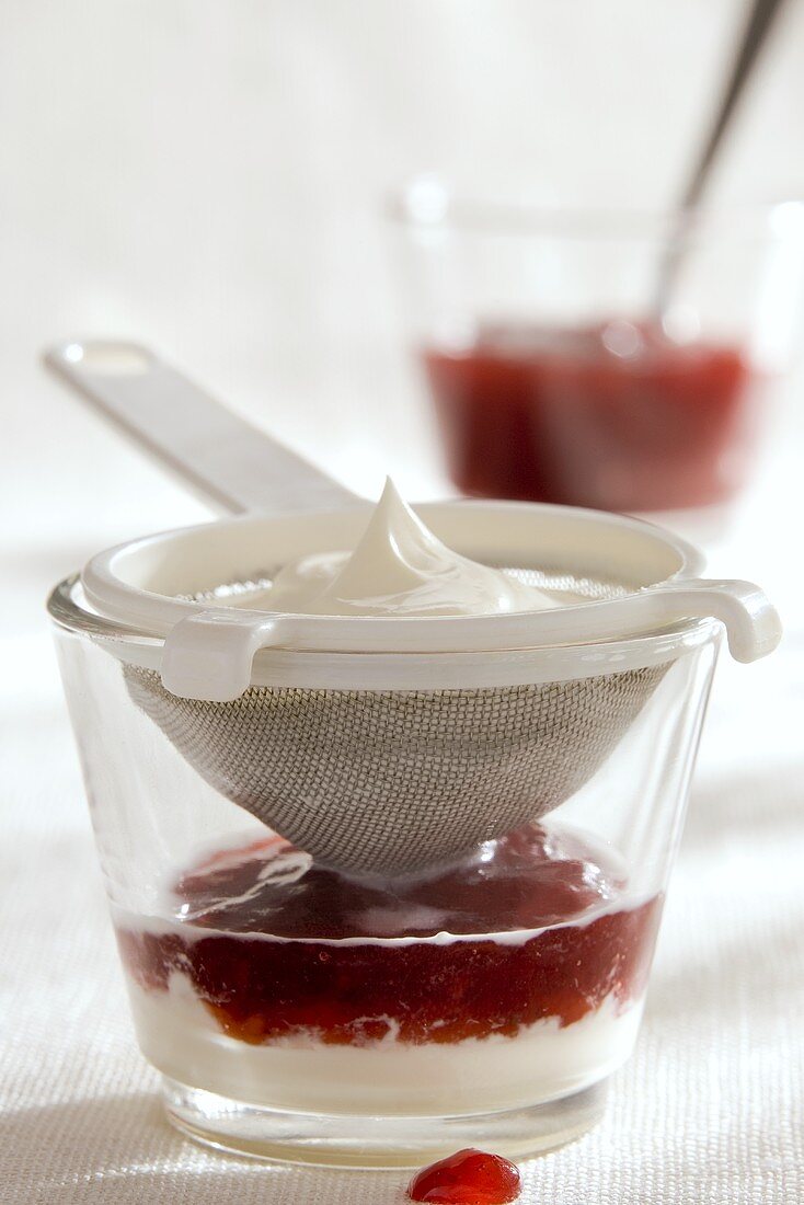 Strawberry compote with yoghurt cream & whipped cream in glass