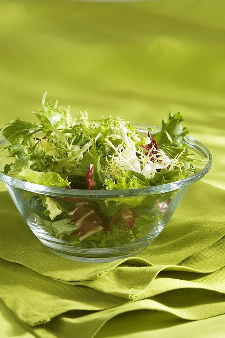 Mesclun (mixed salad leaves) in a glass bowl