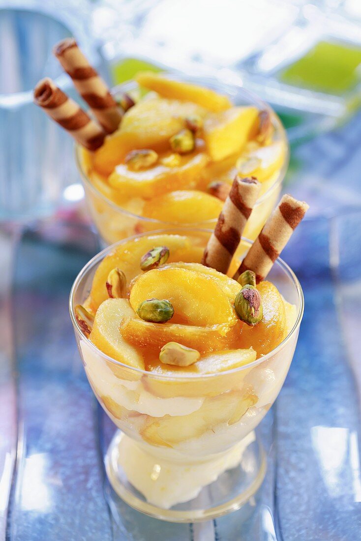 Layered peach and mascarpone dessert with pistachios