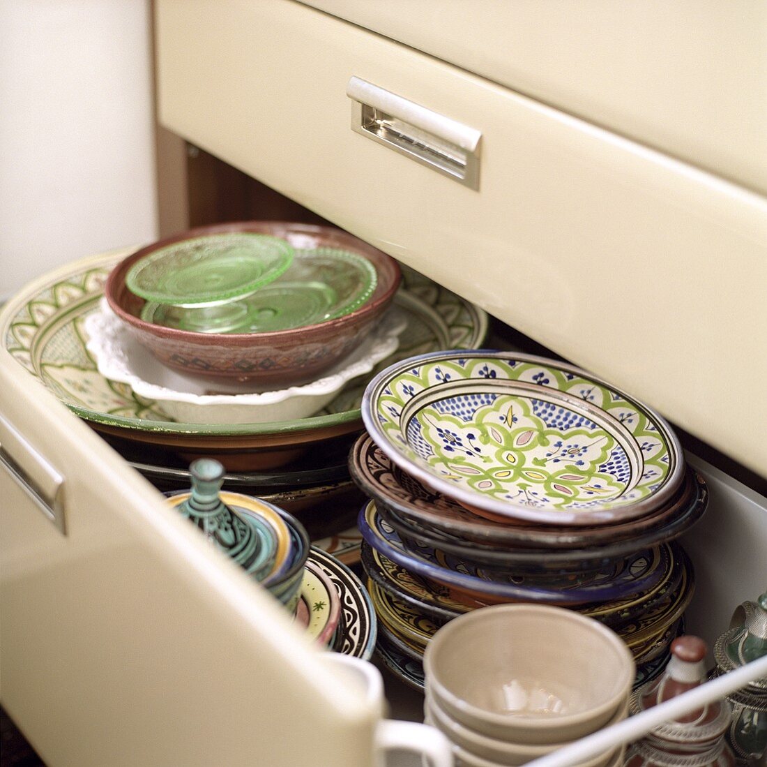 Cololurful crockery in a kitchen drawer