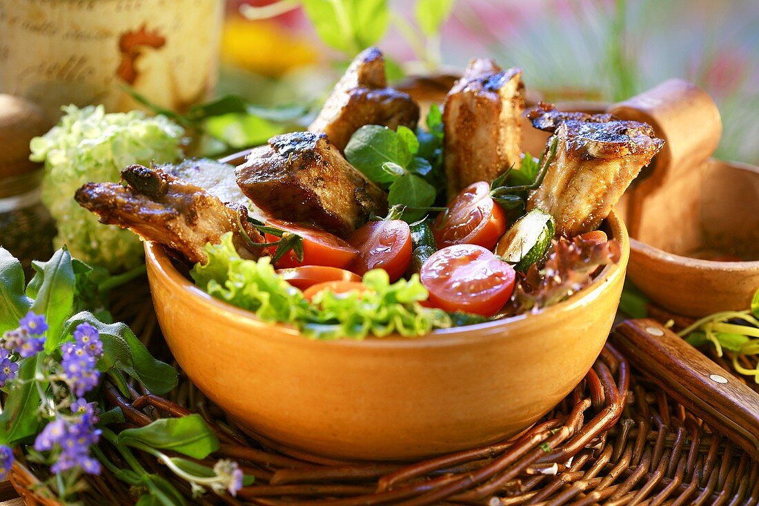 Honey-glazed BBQ spare ribs on salad