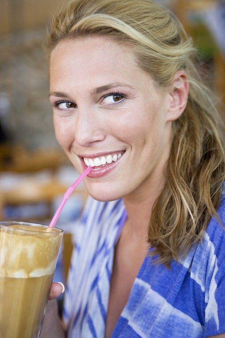 Woman drinking an iced coffee