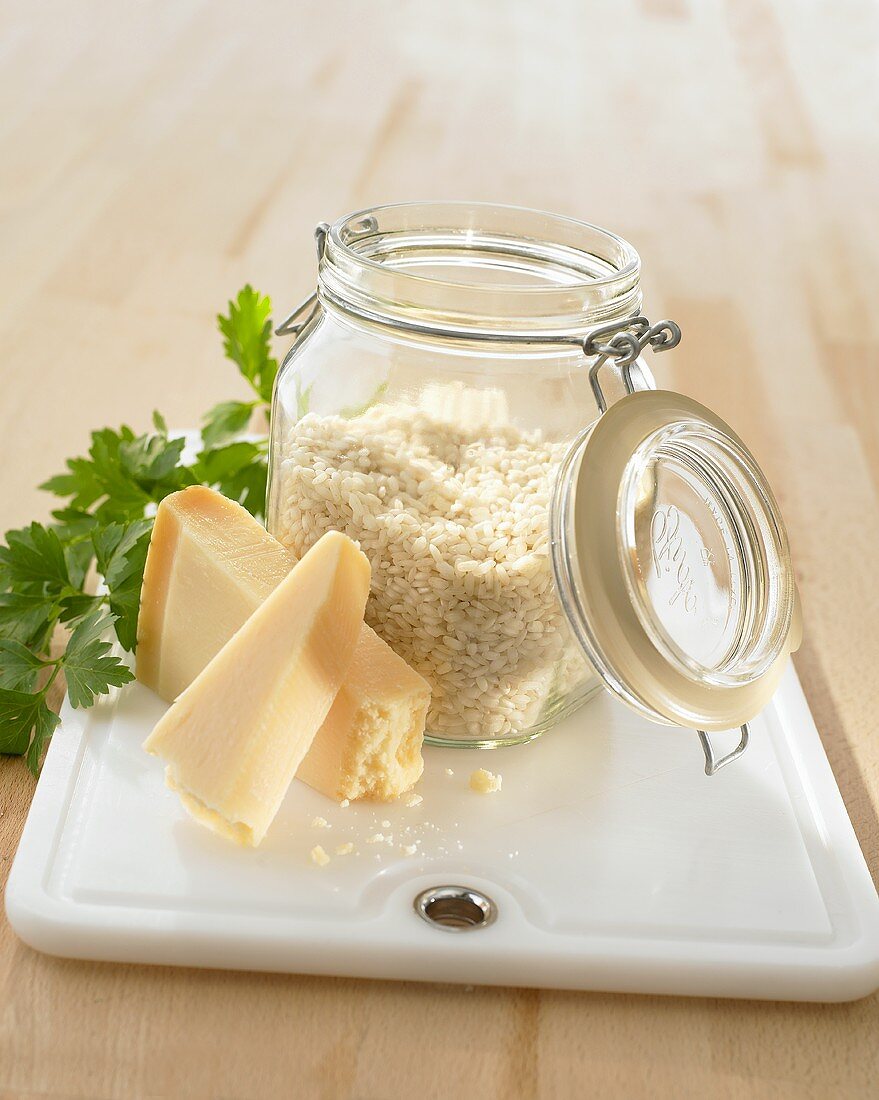 Risotto rice, parsley, Parmesan on kitchen board