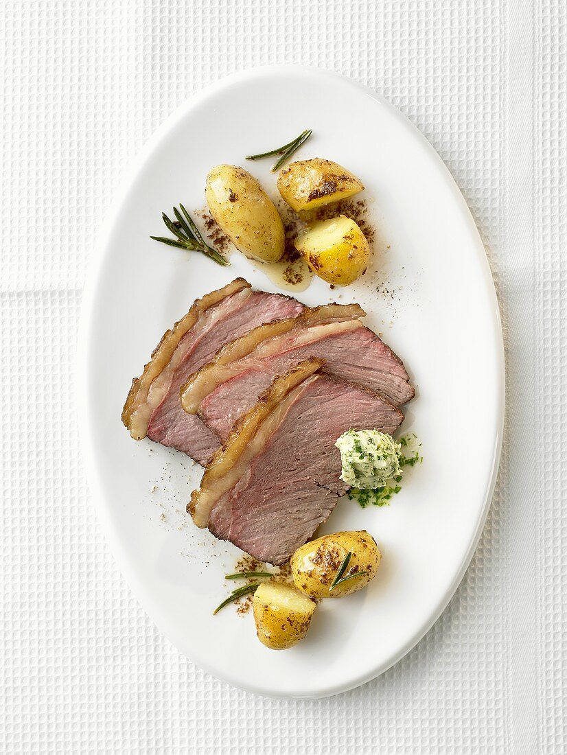 Rump steak with herb butter and rosemary potatoes