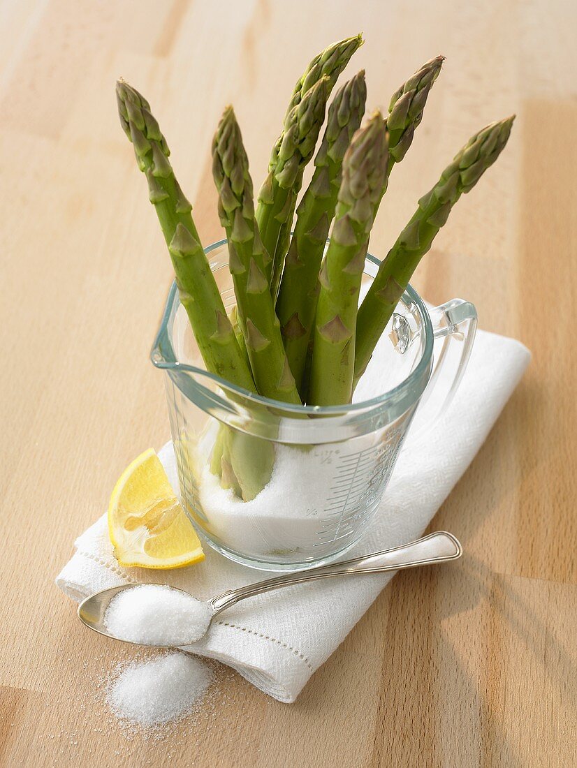 Green asparagus, sugar, lemon (ingredients for cooking asparagus)