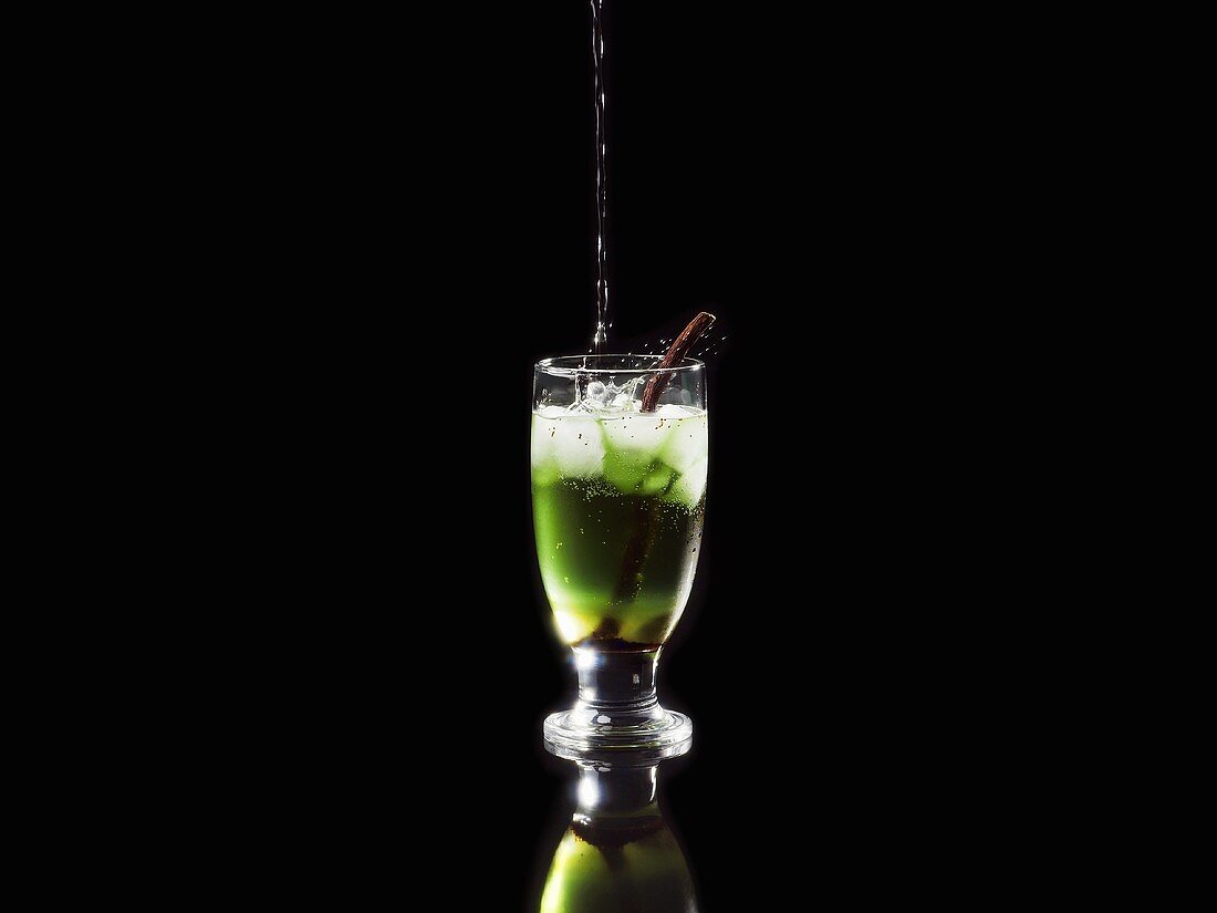 Liquorice and mint cocktail, garnished with liquorice root