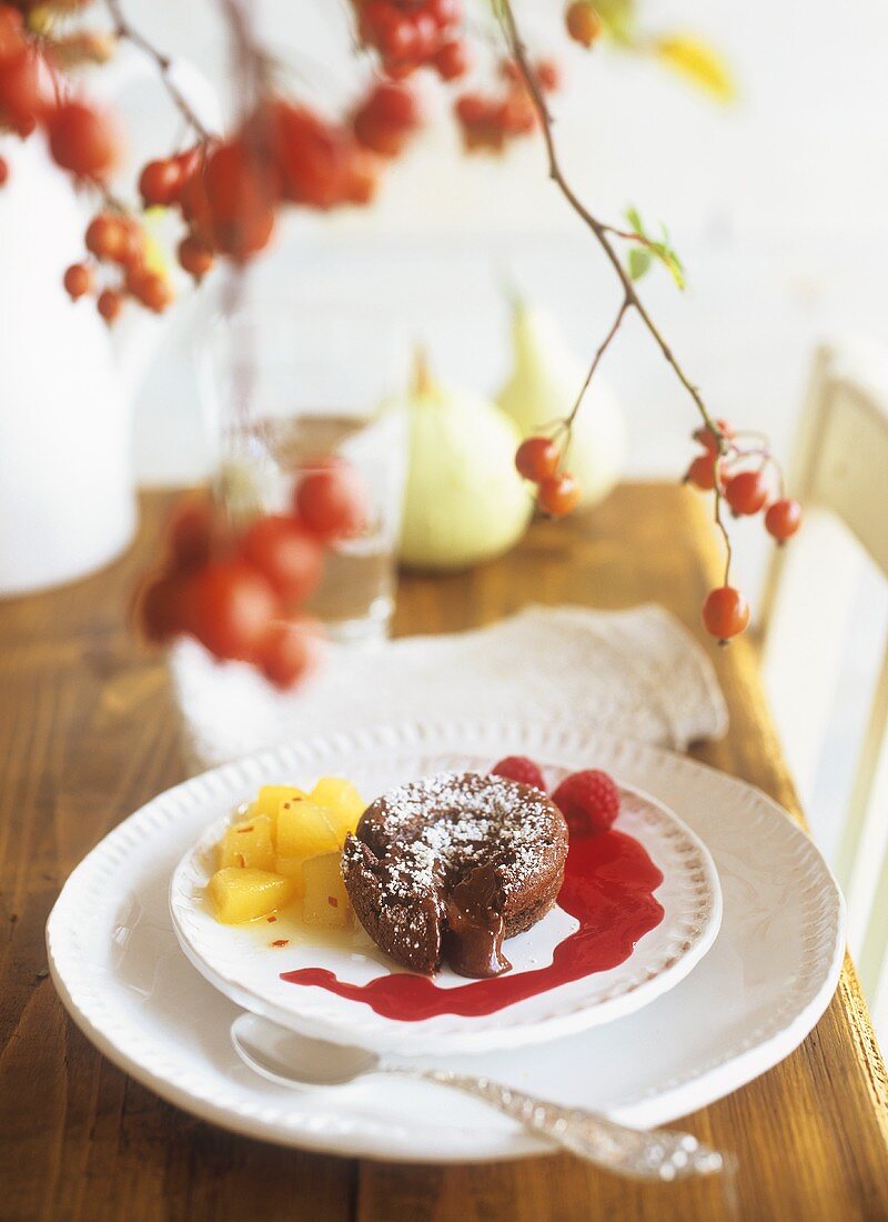 Chocolate pudding with chilli pears and raspberry sauce