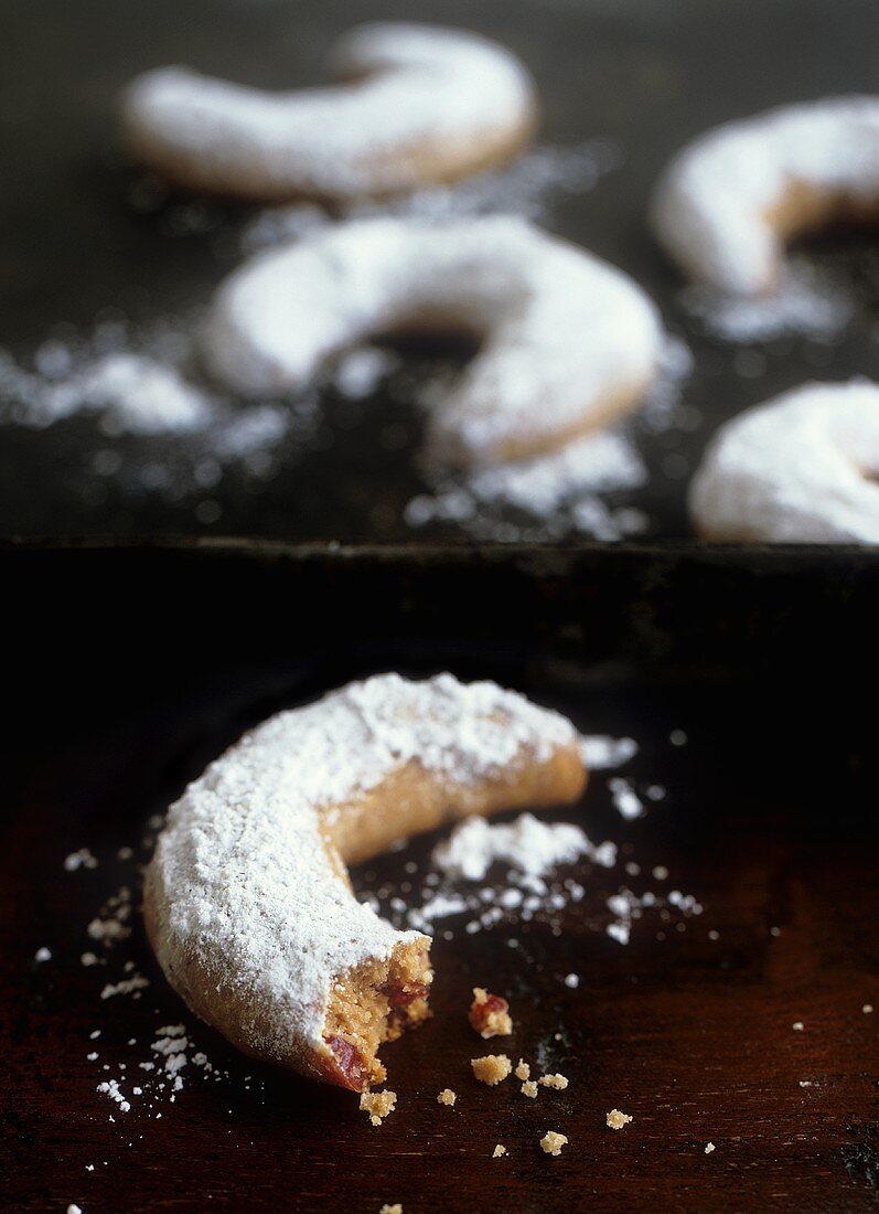 Nougat and cranberry crescents with icing sugar