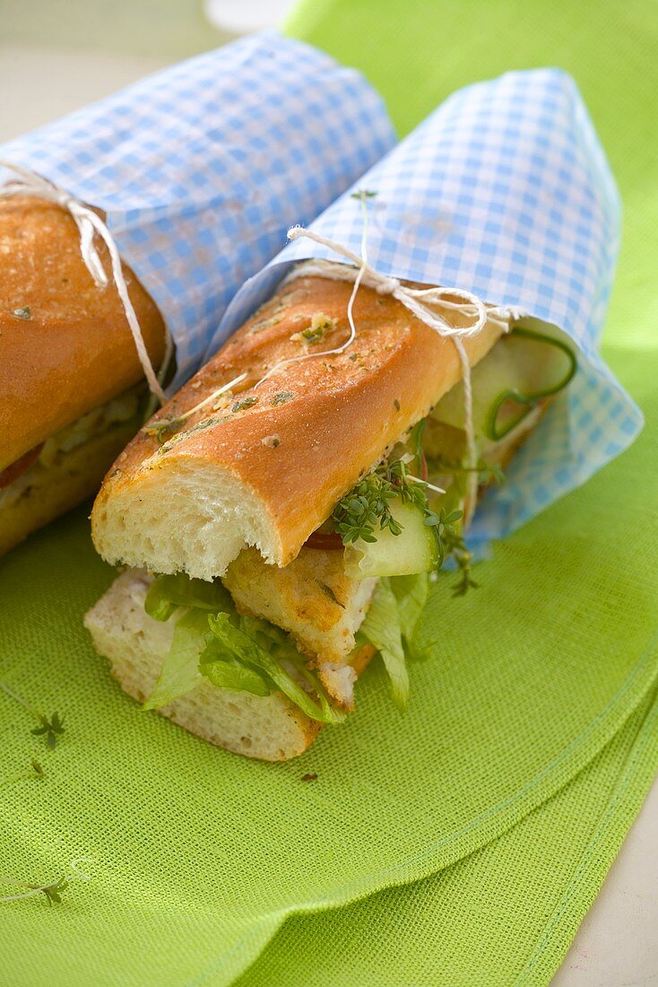 Baguette sandwiches filled with fish, salad and herbs