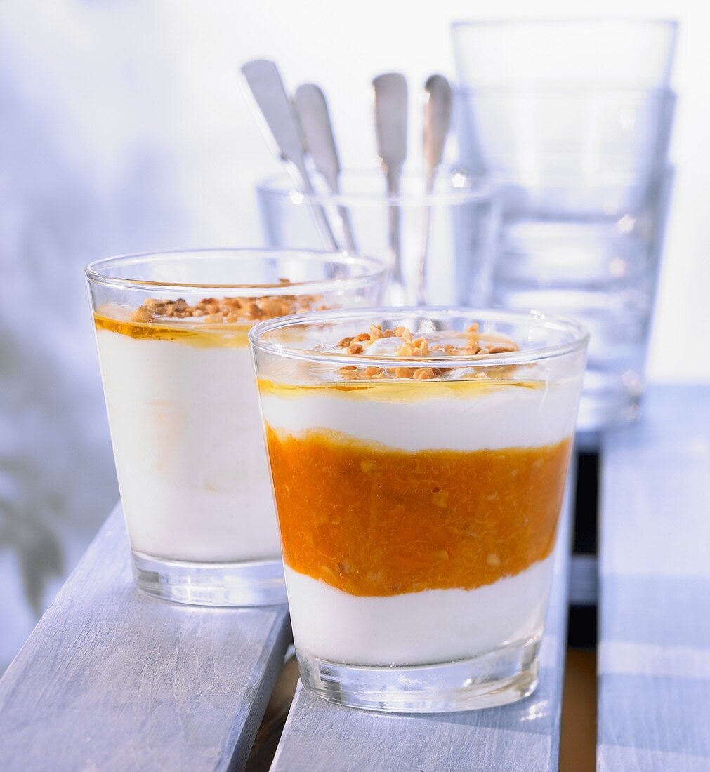 Yoghurt and apricot cream with almonds in glasses