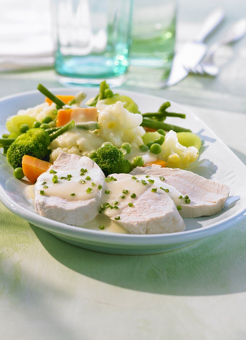 Steamed turkey breast with vegetables & chive cream sauce