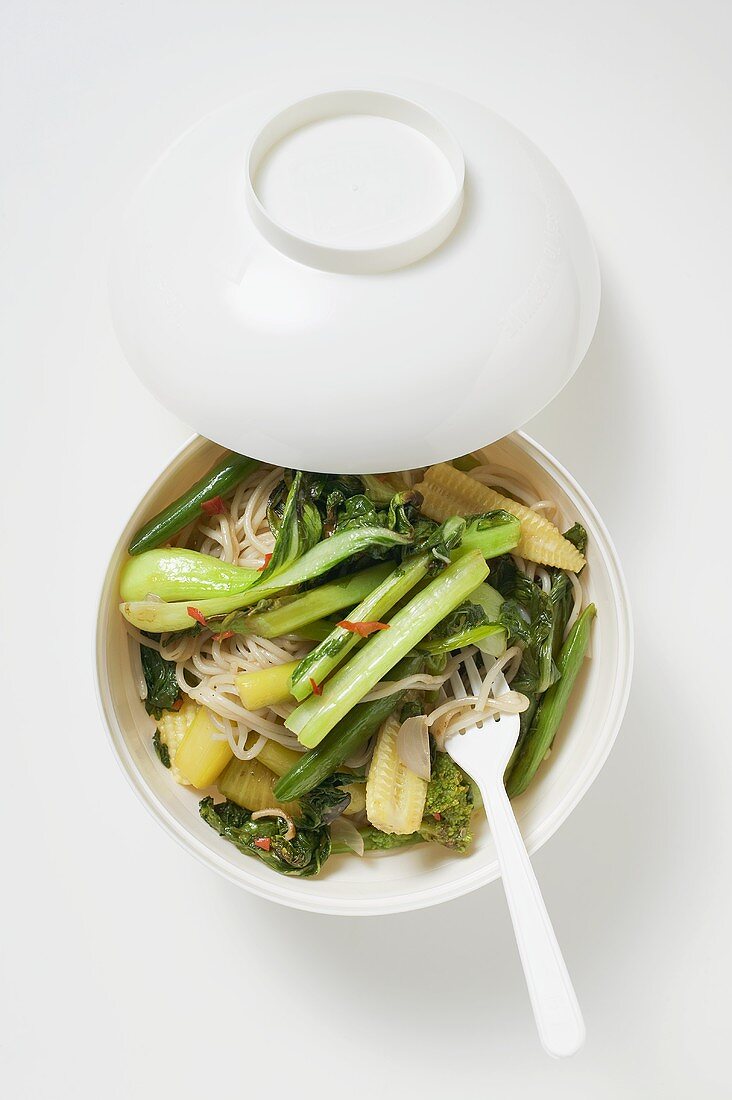 Noodles and vegetables in Asian soup bowl