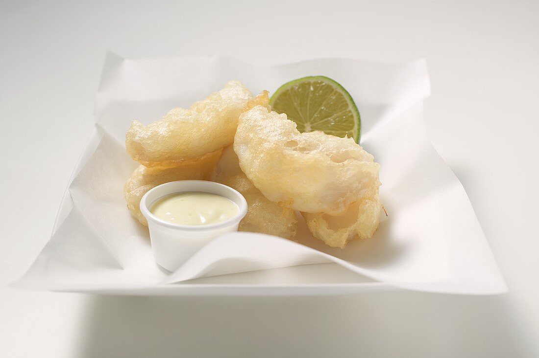 Tempura appetisers with lime mayonnaise on a square plate