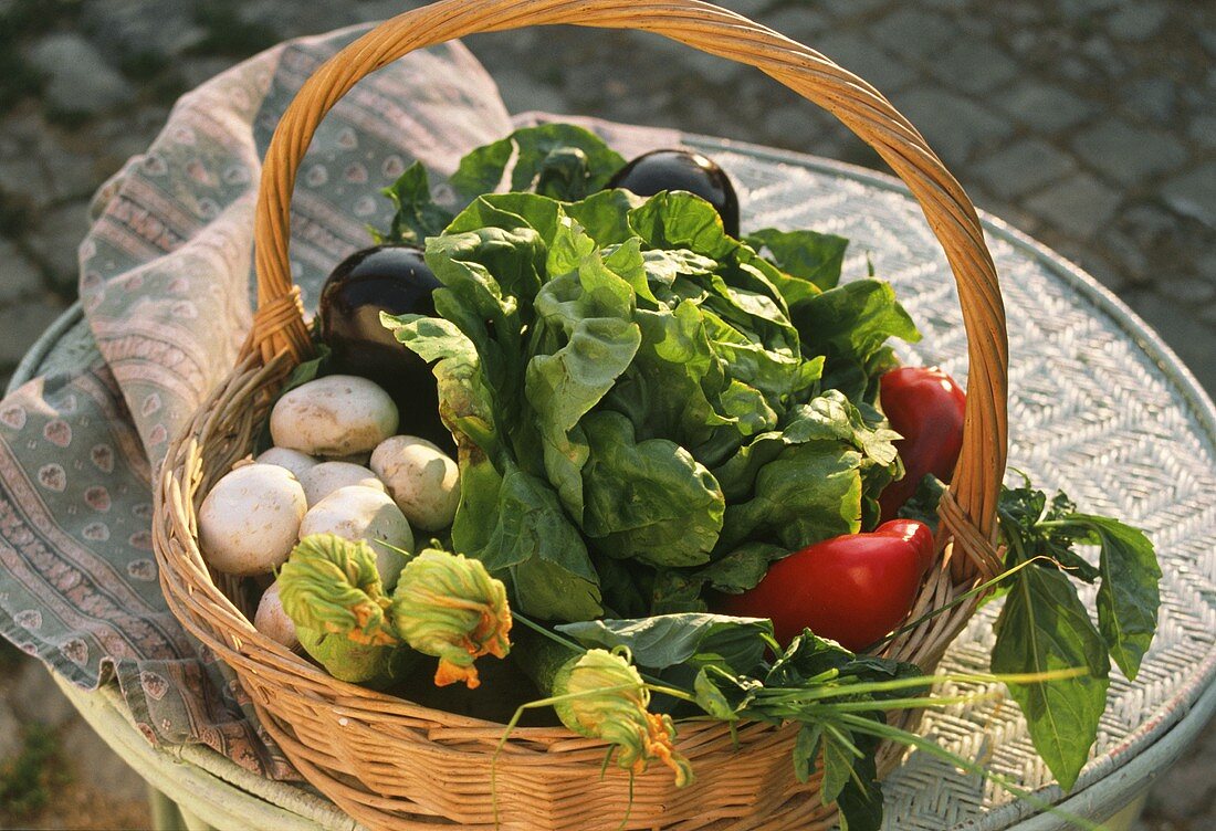 Shopping basket with fresh vegetables and salad