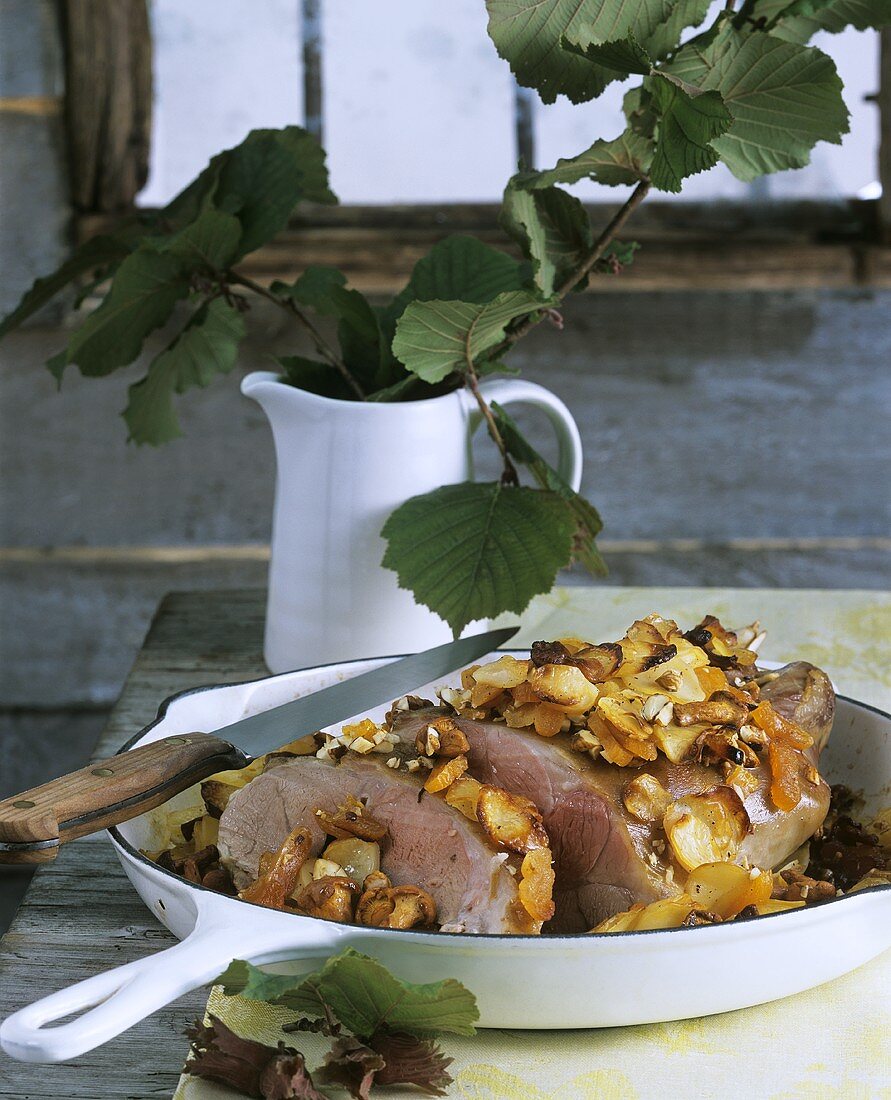 Baked shoulder of lamb with mushrooms and hazelnuts