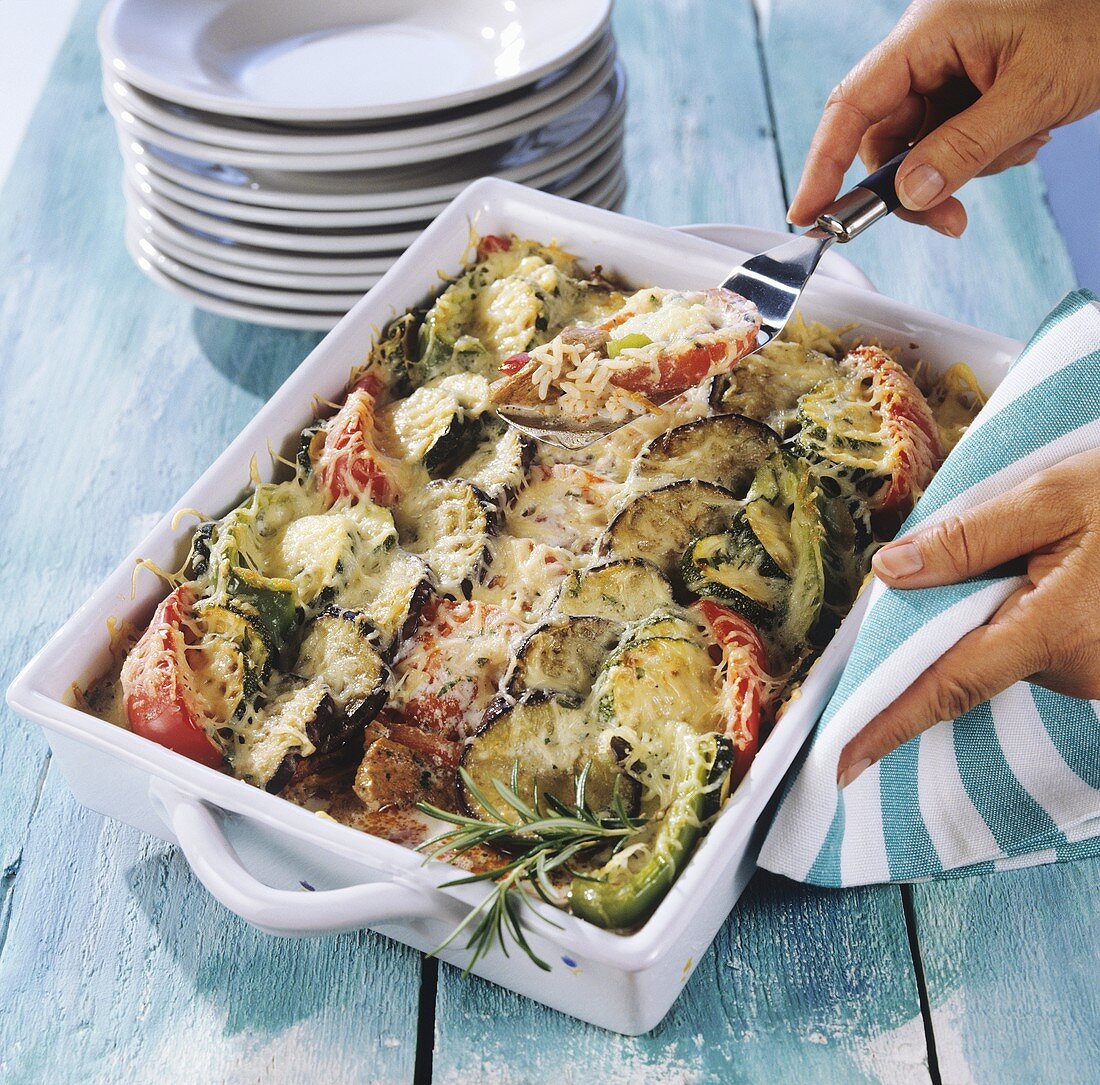 Serving aubergine and gyro meat bake from baking dish