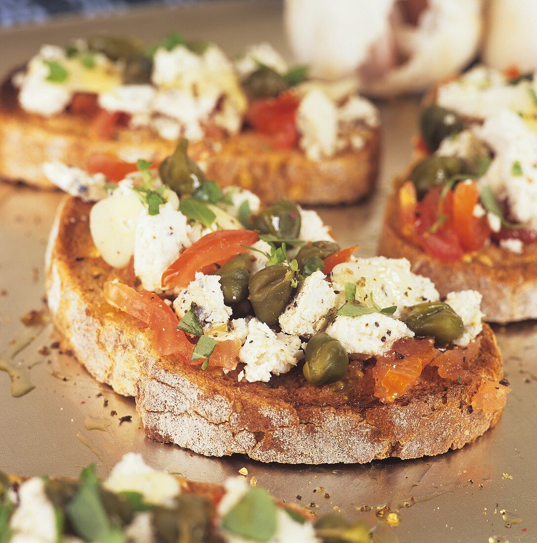 Sheep's cheese, olives and tomatoes on toast