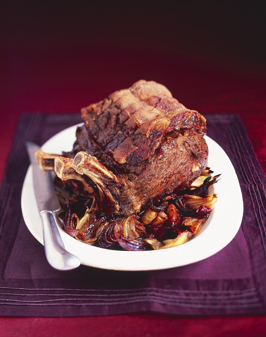 Roast rib of beef with port wine sauce and balsamic onions