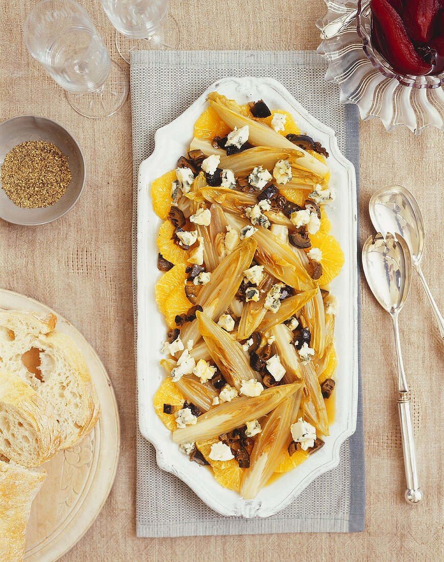 Warm chicory salad with orange segments and Roquefort