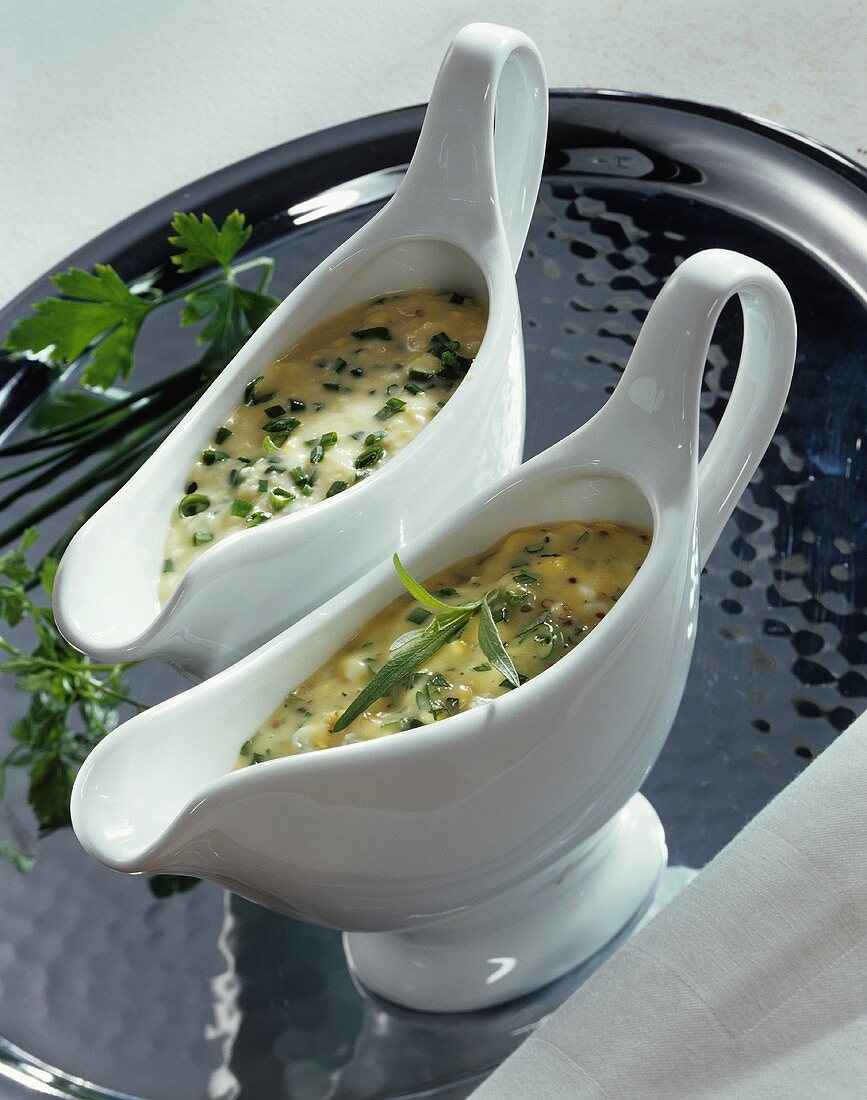 Tartar sauce and chive sauce in two sauce-boats