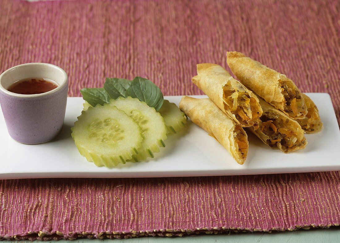 Spring rolls filled with vegetables, cucumber, chilli sauce