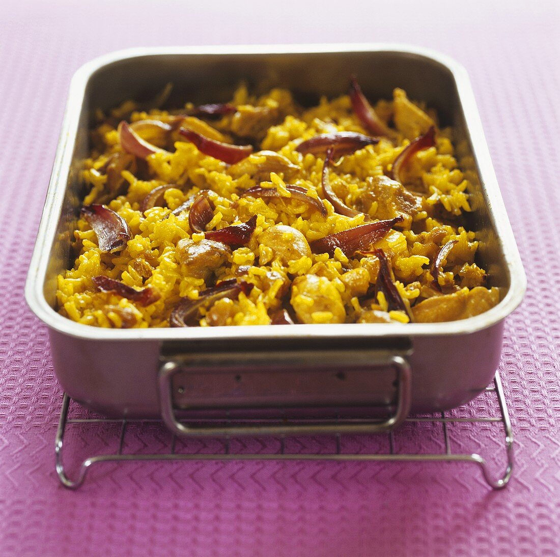 Saffron rice with turkey and onions in a roasting tin