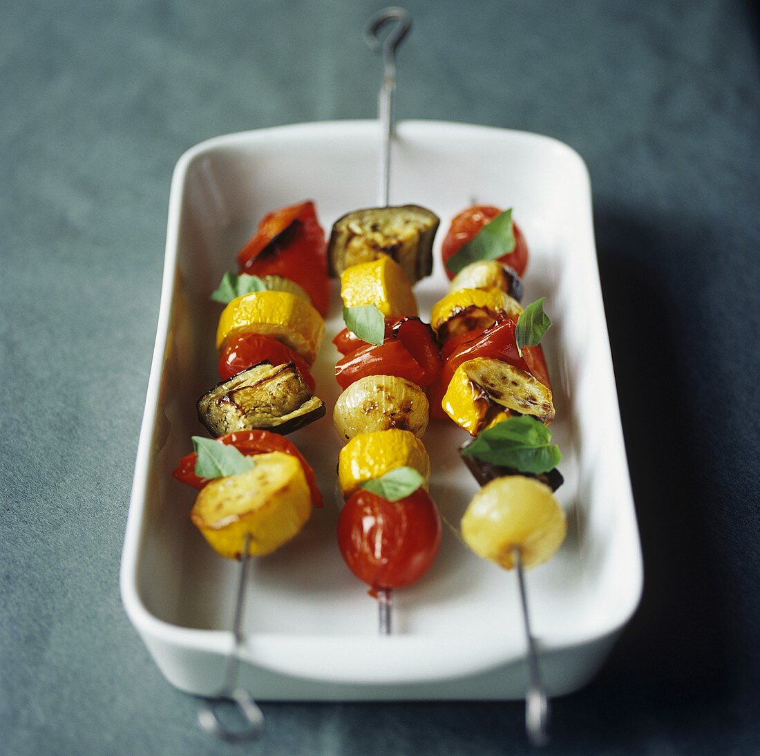 Drei gegrillte Gemüsespiesse mit Tomaten, Paprika, Zucchini