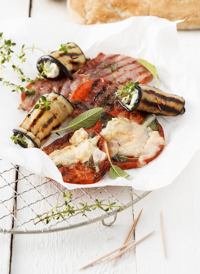 Grilled aubergine rolls and grilled tomato saltimbocca