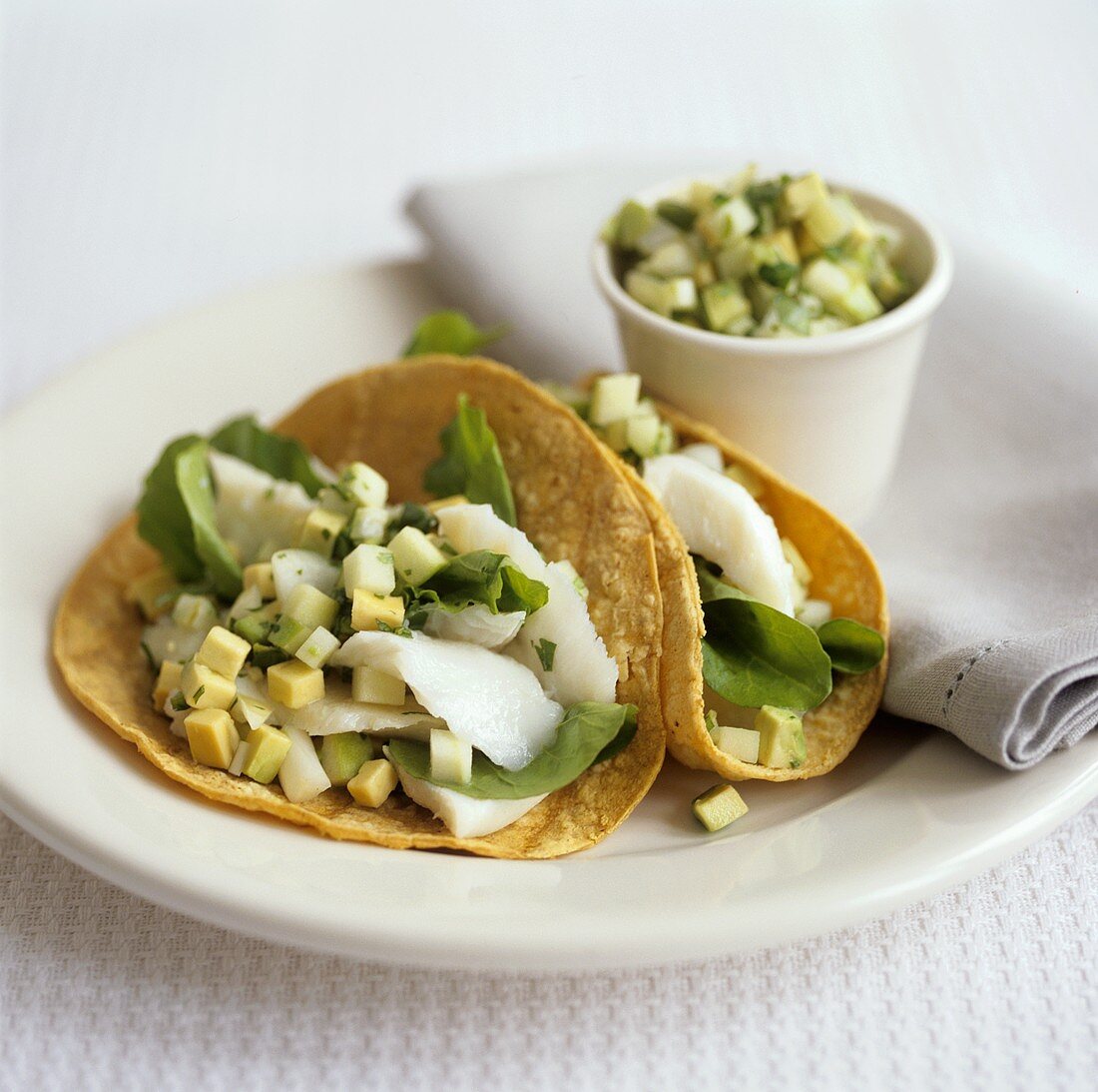 Tacos with avocado, spinach and cod