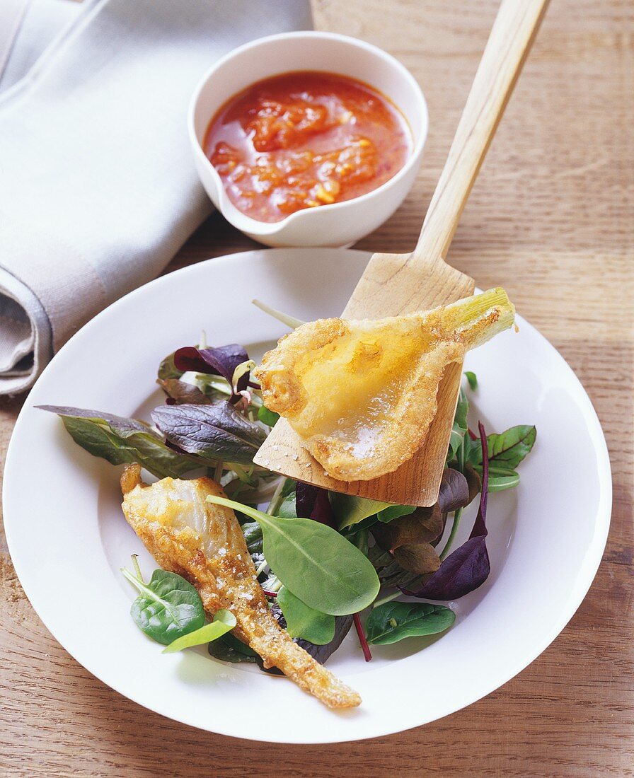 Fennel fritters on salad leaves