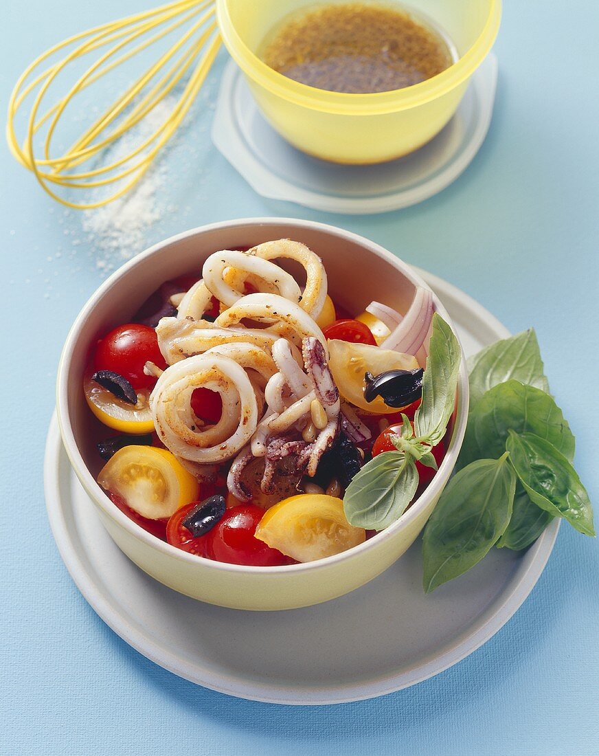 Tomato and olive salad with fried squid rings