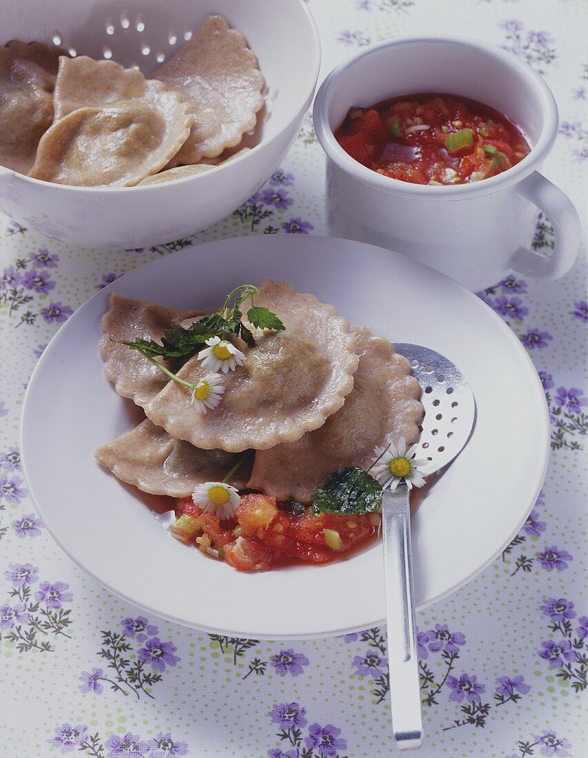 Spelt ravioli with nettle filling and tomato sauce