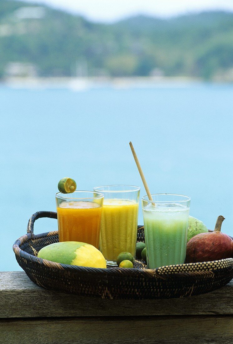 Three exotic fruit drinks out of doors