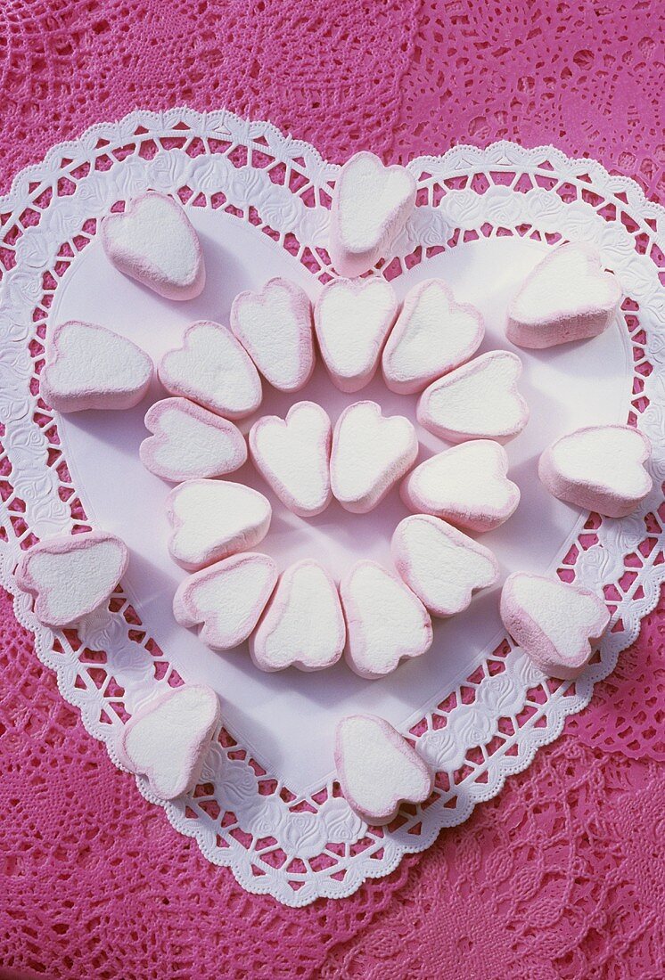 Heart-shaped marshmallows on a heart-shaped paper doily