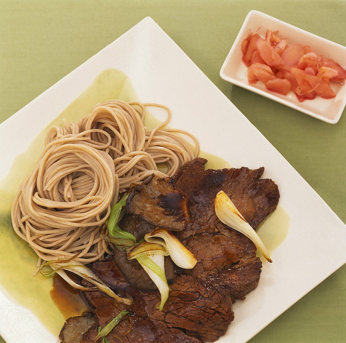Slices of beef with oyster mushrooms and soba noodles