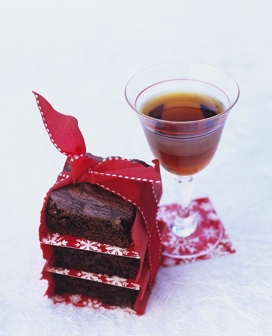 A stack of chocolate chip brownies with dessert wine