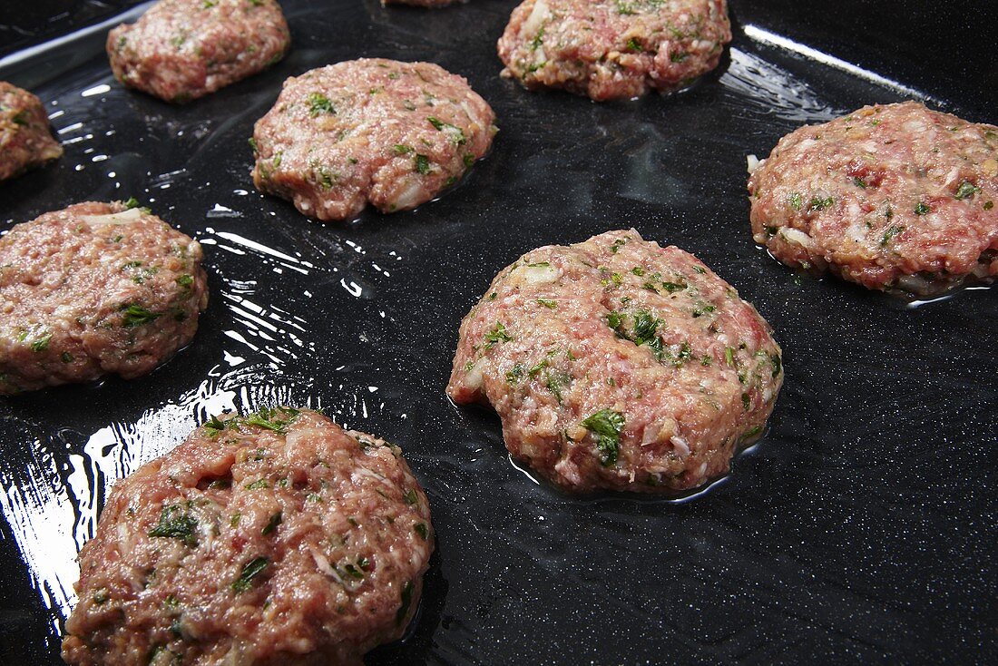 Unfried burgers on a baking tray