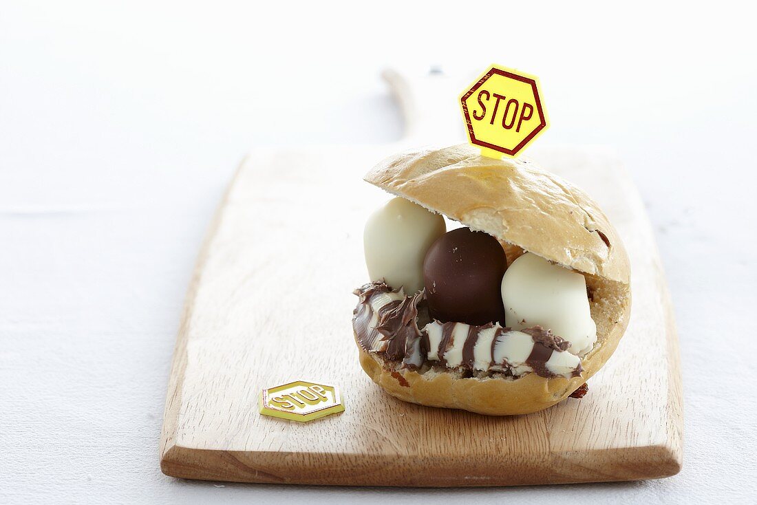 A bread roll filled with chocolate marshmallows and topped with a stop sign