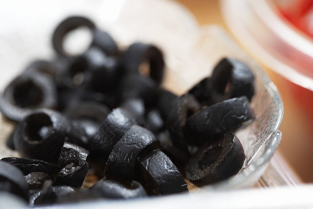 Black olives in a glass bowl